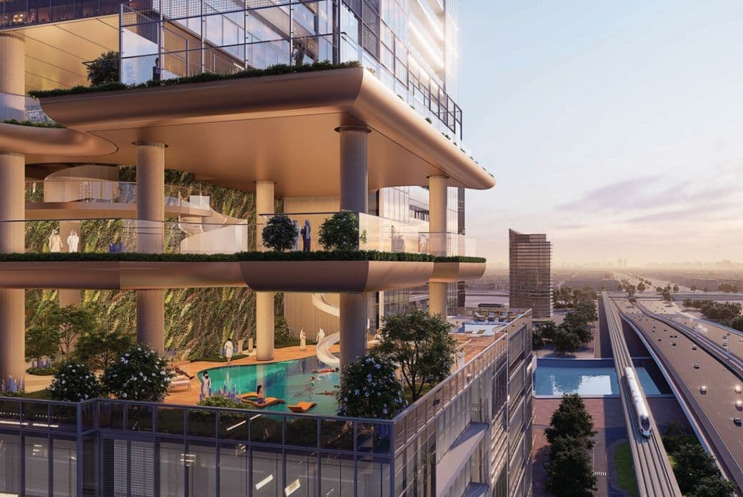 Modern multi-level building with greenery, pool, and open terraces. Adjacent to train tracks, city skyline visible at sunset.