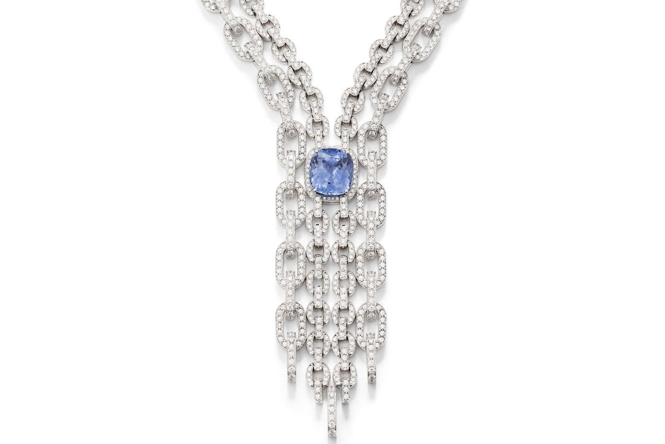 Silver multi-strand necklace featuring a blue cushion-cut centerpiece and cascading diamond-studded fringe.