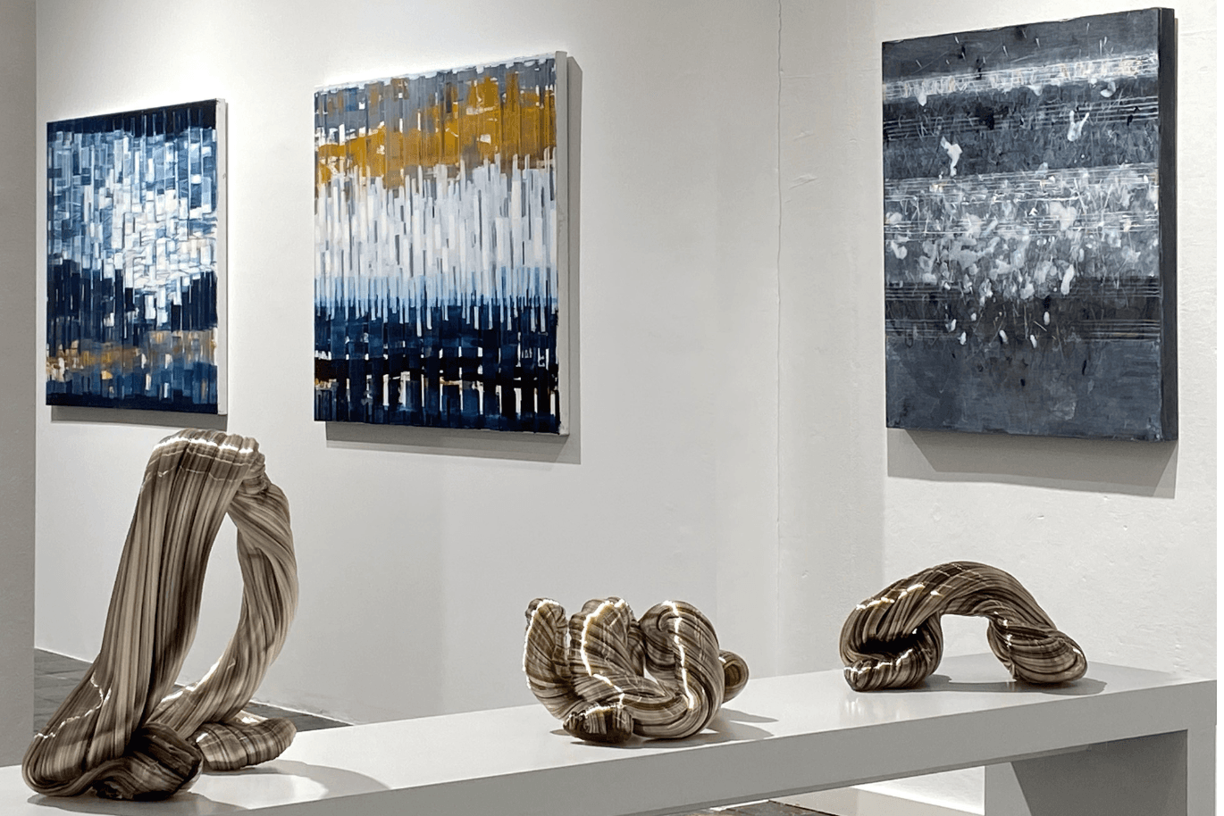 These 3 glass sculptures are exhibited in the Rieck Gallery and look like melted silver wire ropes.