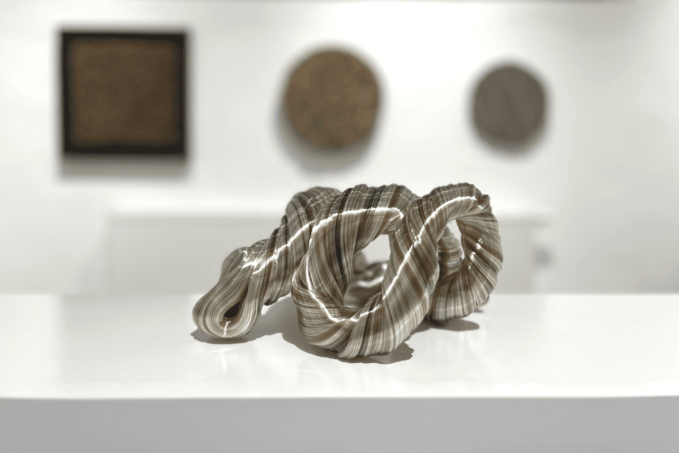 This single sculpture with organic shapes looks like a melted wire rope forming an infinity sign.