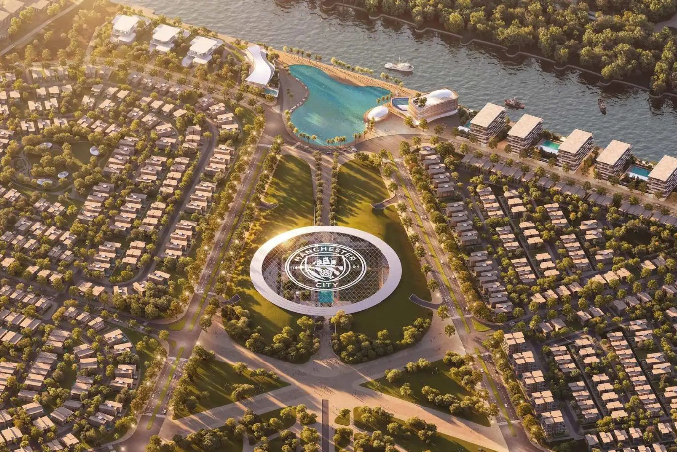Aerial view of a planned community with a circular building labeled "Manchester City," surrounded by houses, trees, a lake, and a river.