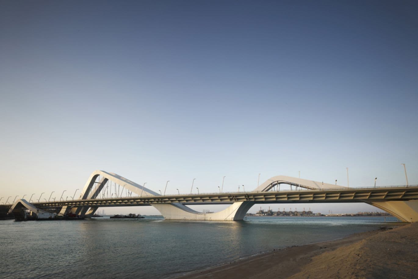 Sunny scene with Sheikh Zayed Bridge over river in Abu Dhabi