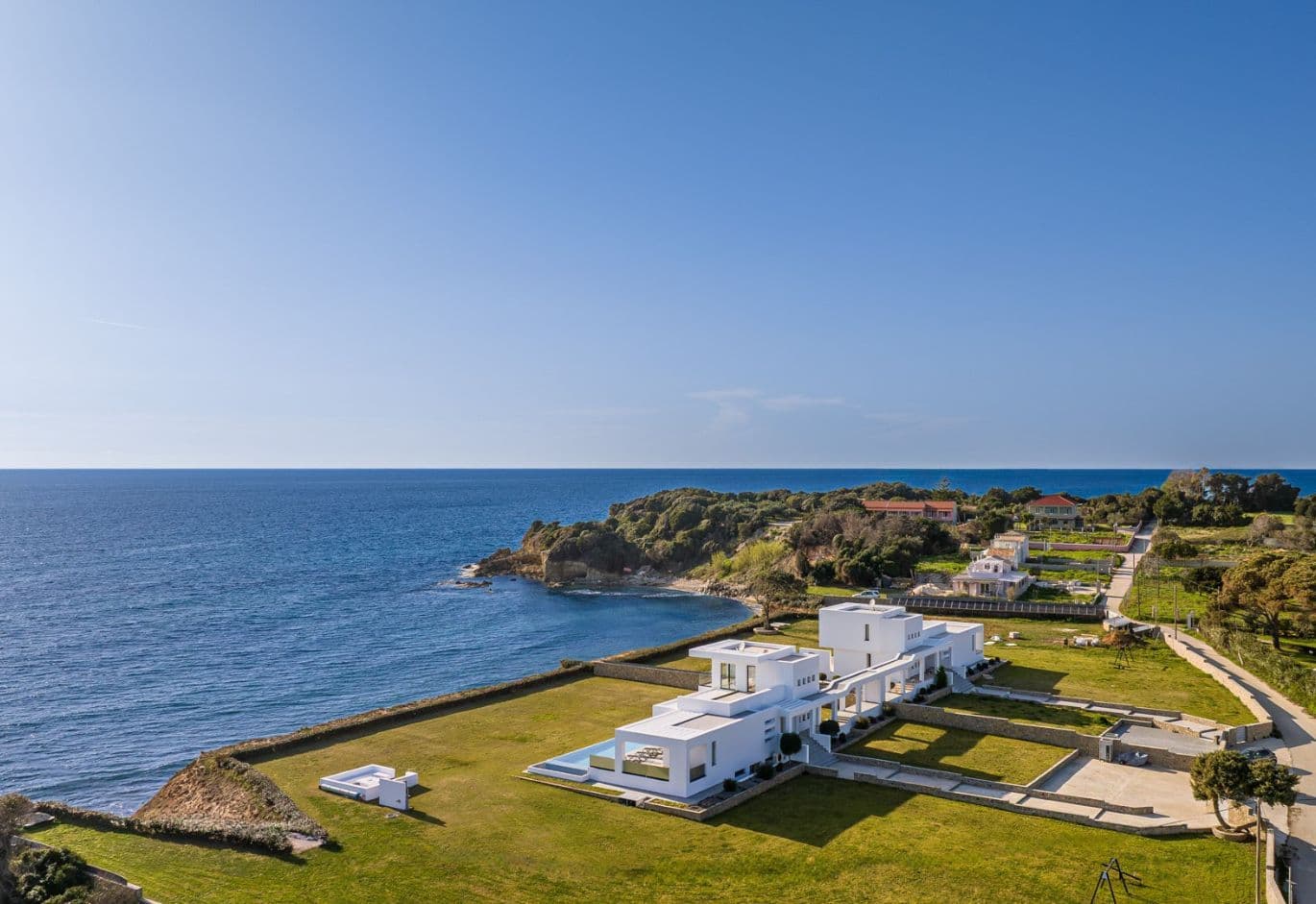 Modern seaside villa with expansive garden, coastal views, and surrounding countryside