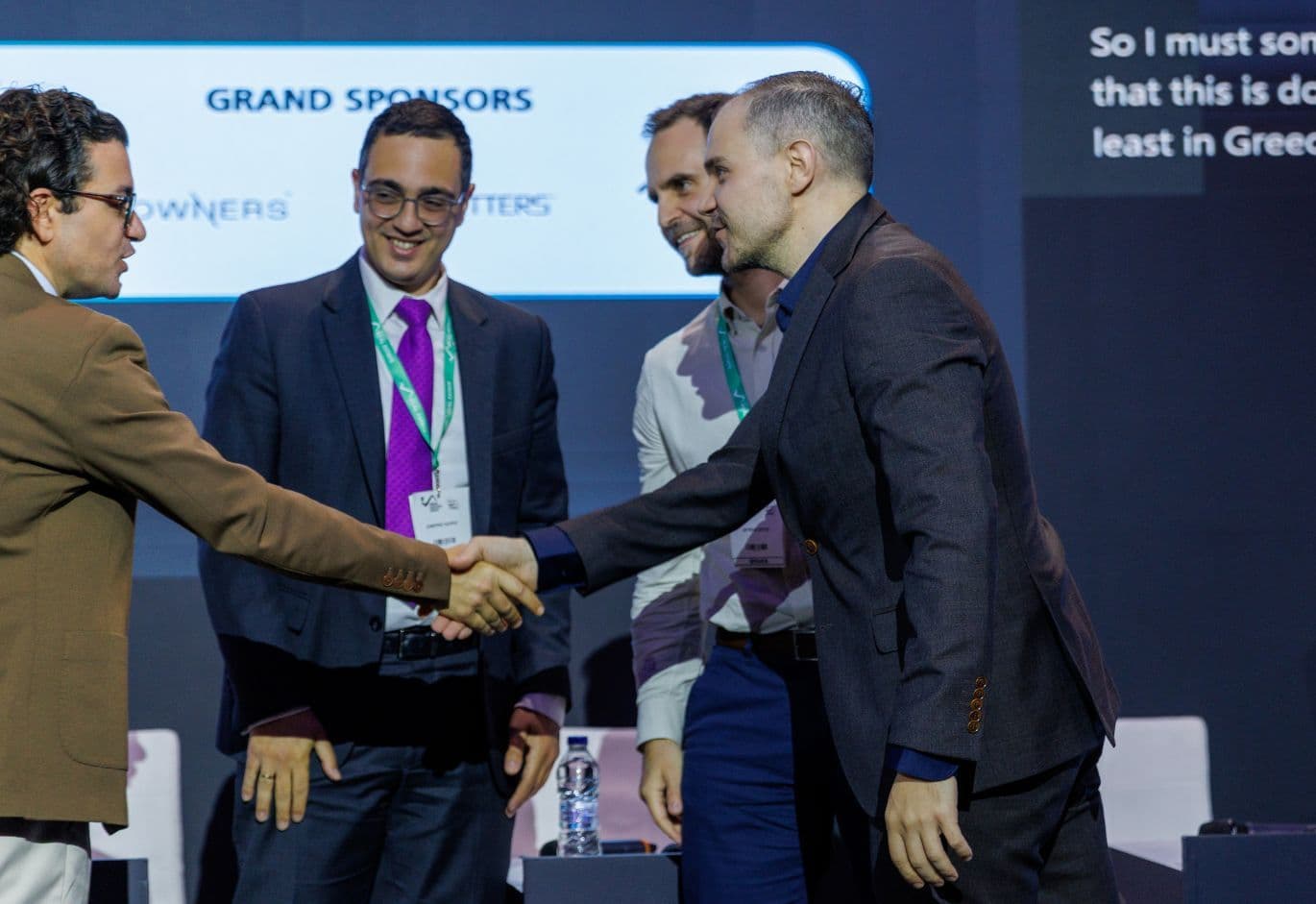 Business professionals networking and shaking hands during the Real Estate Forum event