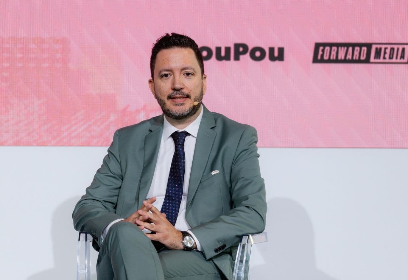 Speaker participating in a panel discussion at White Paper The Event, addressing the audience during a business conference
