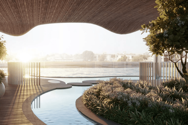 Modern outdoor space with a curved wooden roof, pool, greenery, and a view of water and distant buildings at sunrise or sunset.