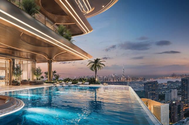 An elevated infinity pool at Shahrukhz with panoramic views of Dubai, featuring lush landscaping, elegant seating areas, and ambient lighting at dusk.