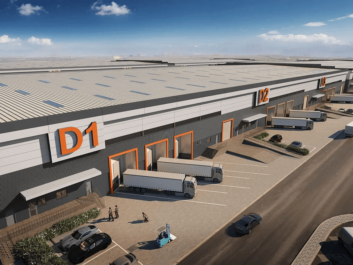 Aerial view of a large industrial warehouse complex with multiple loading docks, trucks, and parking areas, under a clear blue sky.
