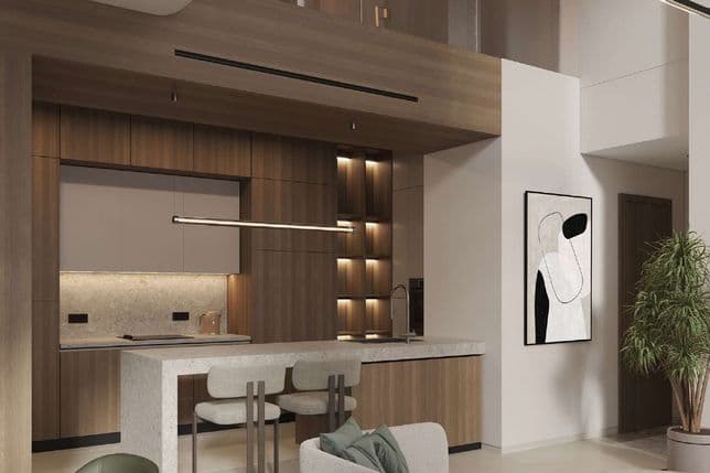 Modern open-plan living space with wood accents, featuring a kitchen island, abstract art, green armchairs, and a potted plant.