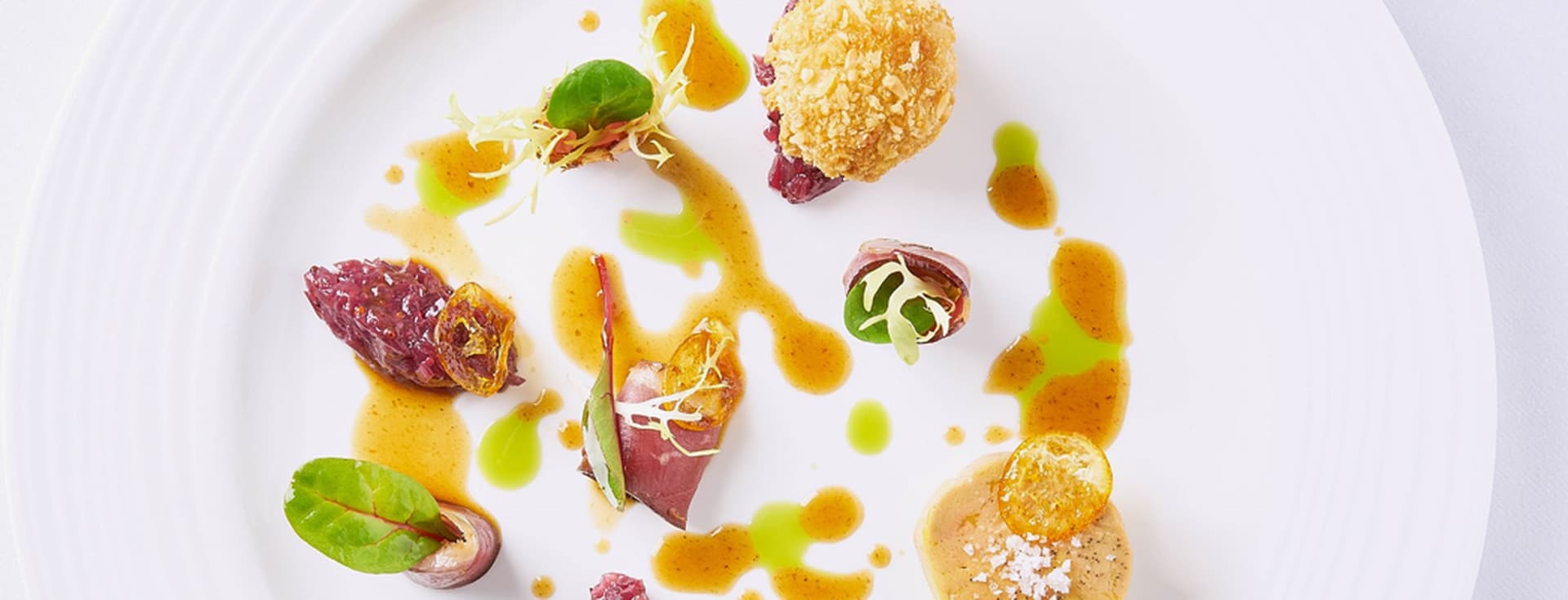 A gourmet dish artfully arranged on a white plate.