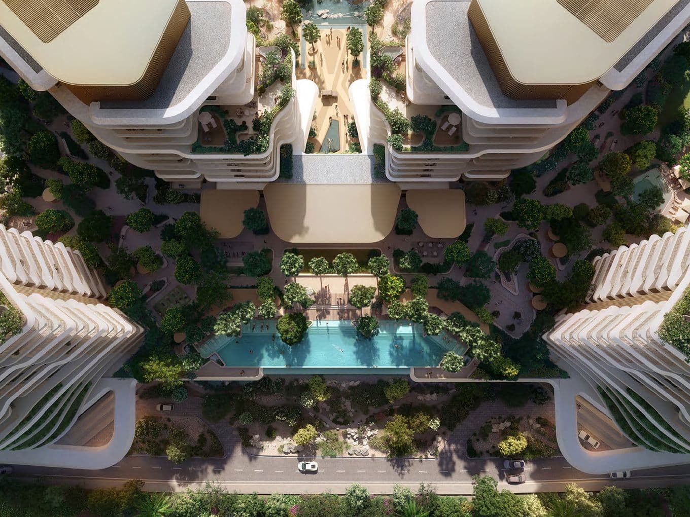Aerial view of modern architectural complex with curved buildings, lush greenery, and a central swimming pool, adjacent to a road.
