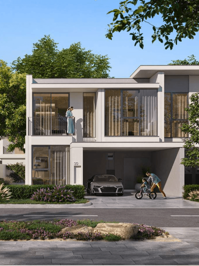 Eine moderne Townhouse Aussenansicht in Vindera at The Valley mit grossen Fenstern, privatem Parkplatz, begruentem Umfeld und Bewohnern, die den Aussenbereich nutzen.