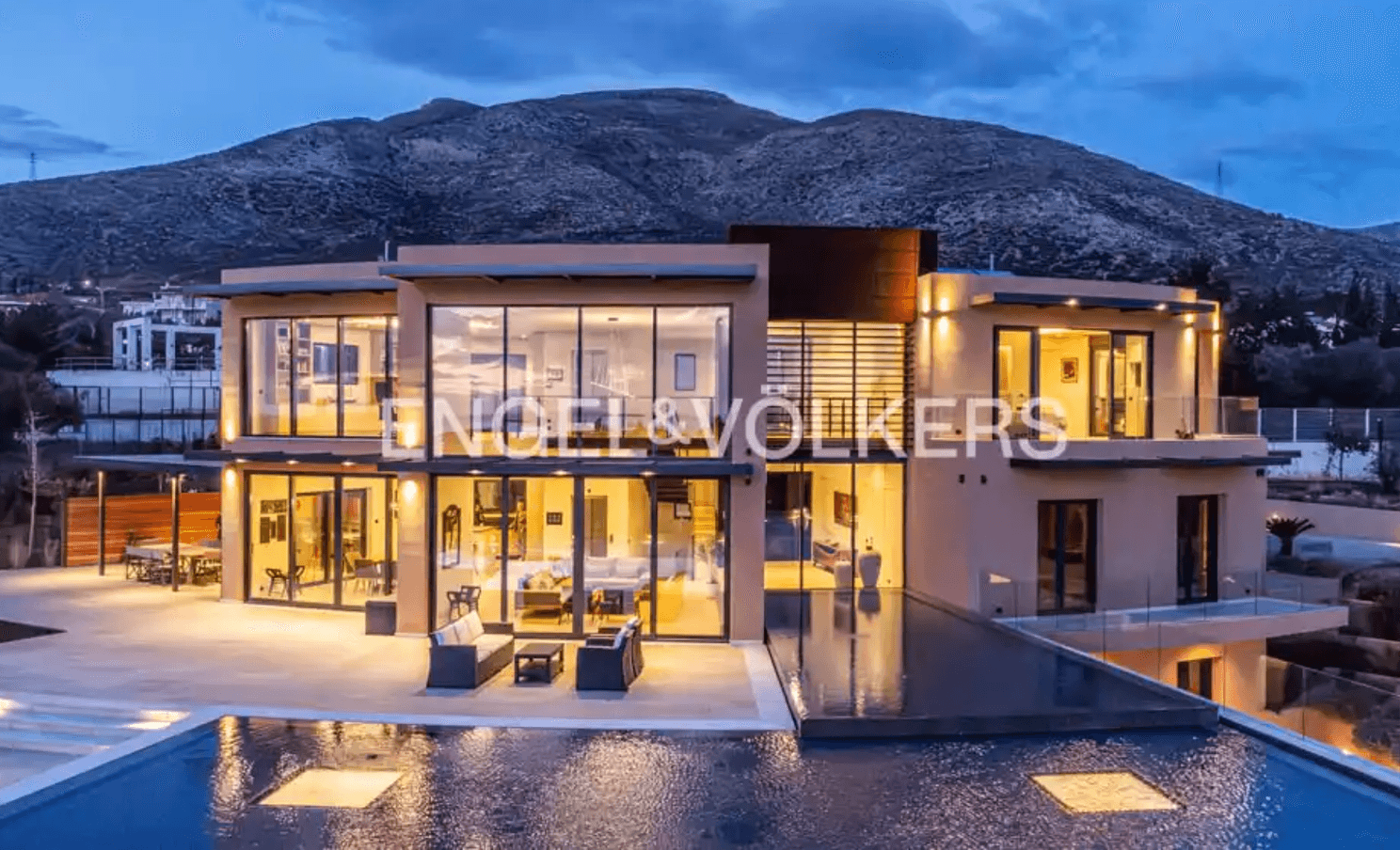 Front photo from a smart villa in Athens during night with open lights