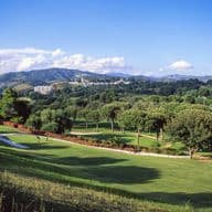 Rio Real golf course surrounded by green plants and mountains