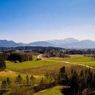 Expansive aerial view of Penzberg in Bavaria, Germany, with Alpine panorama, forests and meadows – a scenic place for residential living