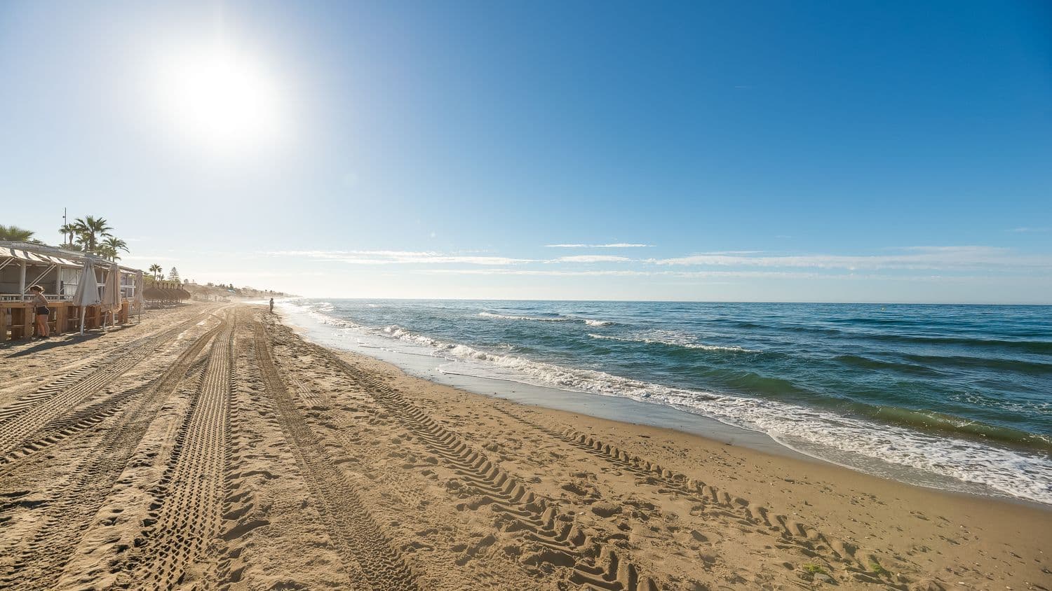 Sunset next to the beach of El Rosario, with beach bar on the left