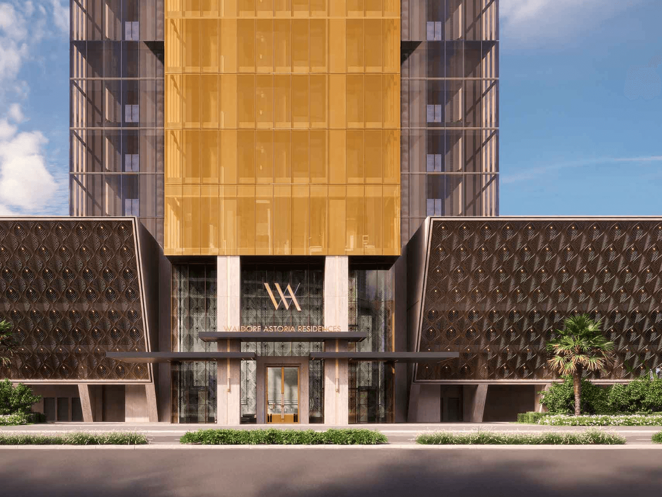 Moderner Gebäudeeingang mit goldener Fassade, geometrischen Mustern und Palmen. Über den Türen prangt das markante „WA“-Logo.