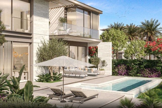 Modern villa with large windows, pool, and patio furniture. Surrounded by lush greenery, palm trees, and colorful flowers under a clear blue sky.
