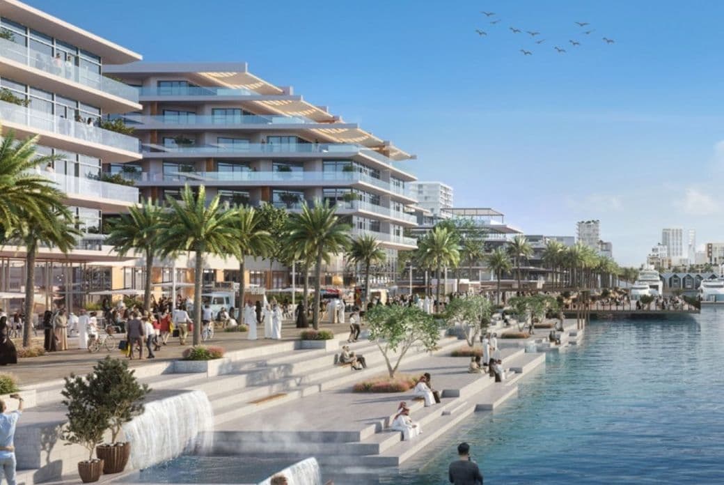 Lively waterfront promenade at Mina Rashid, featuring modern low-rise residences with large balconies, palm trees, cascading water features, outdoor dining areas, and people walking, relaxing, and enjoying the marina views under a clear blue sky.          Ask ChatGPT