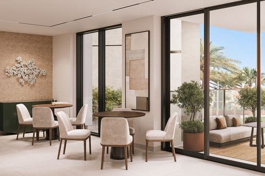 Modern lounge area with round tables and upholstered chairs, large windows overlooking a patio with seating, potted plants, and palm trees.