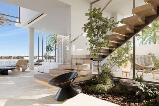 Modern open living space with a floating staircase, indoor plants, large windows, and minimalist furniture. Bright and airy ambiance.
