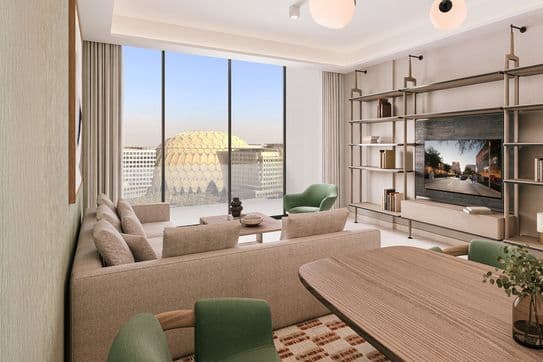 Modern living room with beige sofas, green chairs, and a large TV. Floor-to-ceiling windows offer a view of a dome structure outside.