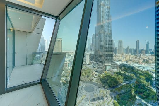 Interior balcony space at Burj Vista in Dubai with angled glass panels and an impressive view of the Burj Khalifa and cityscape.
