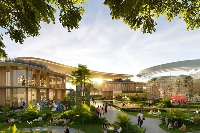 A landscaped park at DAMAC Islands 2 with people walking, playing, and using open green spaces surrounded by trees, pathways, and water features.