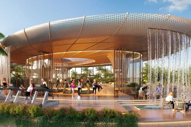 An open air fitness and leisure pavilion featuring treadmills, seating areas, and cascading water features under a curved canopy structure.