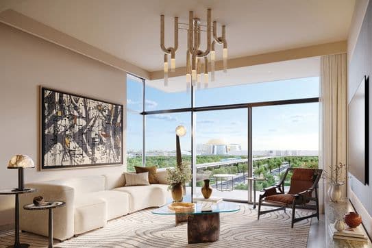 Modern living room with a white sofa, abstract art, glass coffee table, and large windows showing a cityscape view. Elegant lighting fixture above.