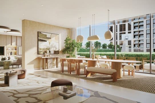 Modern open-plan living and dining area with large windows, light wood furniture, abstract art, and a view of greenery and a building outside.