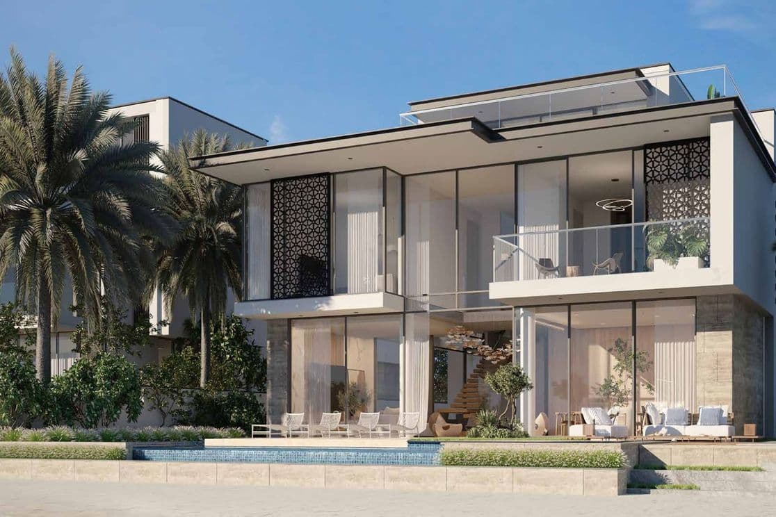Modern beachfront villa with large glass windows, palm trees, and a pool. Sunlit exterior and contemporary design elements.