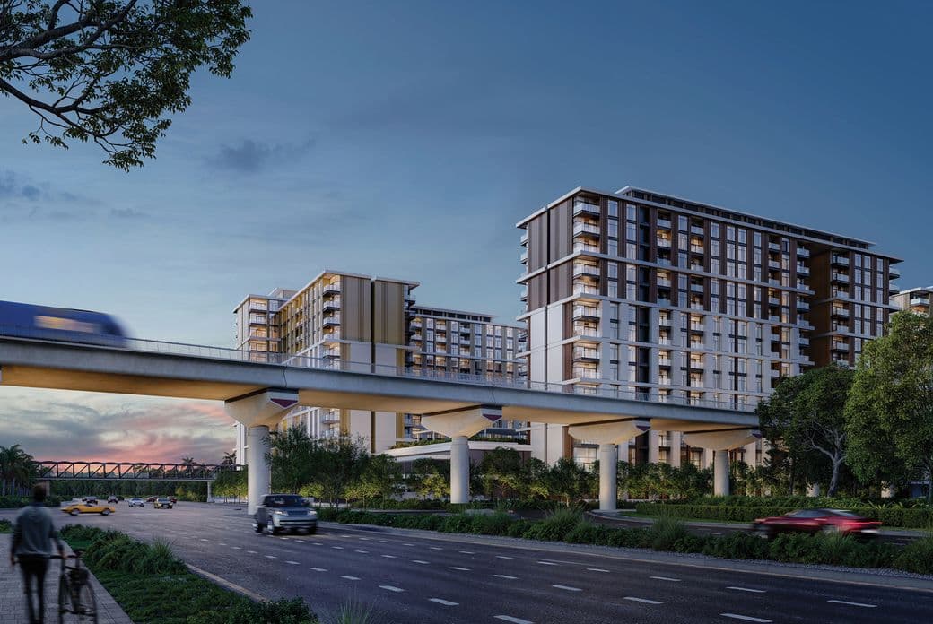Modern urban scene at dusk with high-rise buildings, a train on an elevated track, and cars on a multi-lane road lined with trees.
