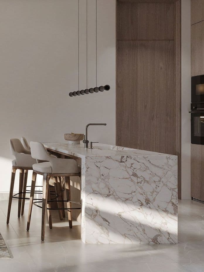 Open-plan dining and kitchen area in a Pinewood Estate Home, featuring a marble dining table, soft-tone modern chairs, wood panel finishes, and integrated elevator access.