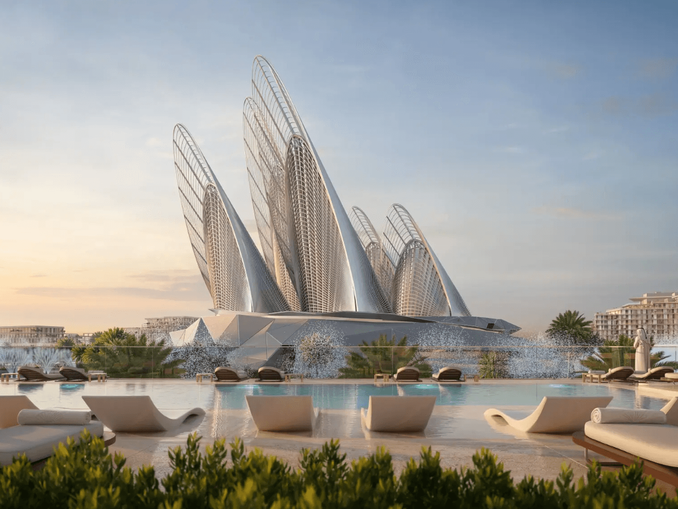 Futuristic building with sail-like structures by a pool, surrounded by modern architecture and palm trees, under a clear sky.