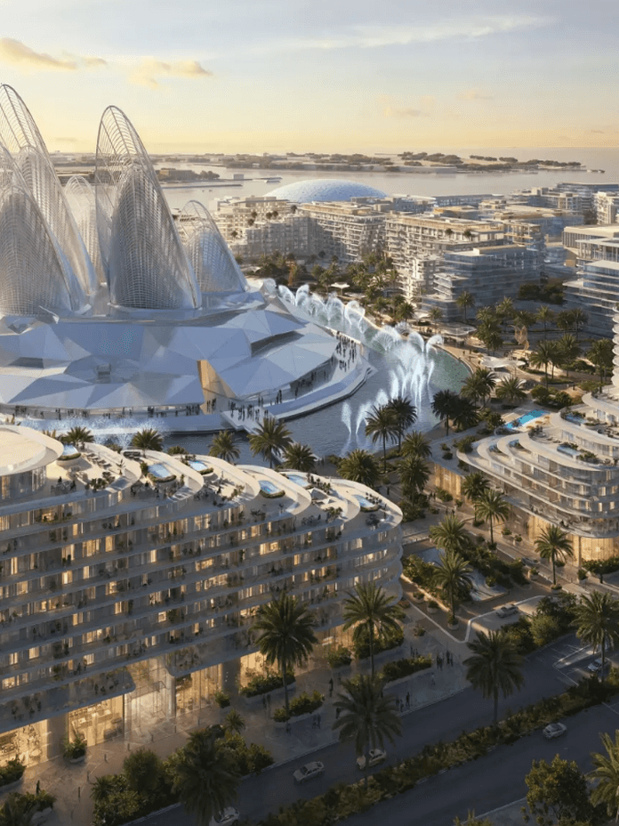 A futuristic coastal cityscape at sunset, featuring modern architecture with curved buildings and a prominent domed structure surrounded by greenery.