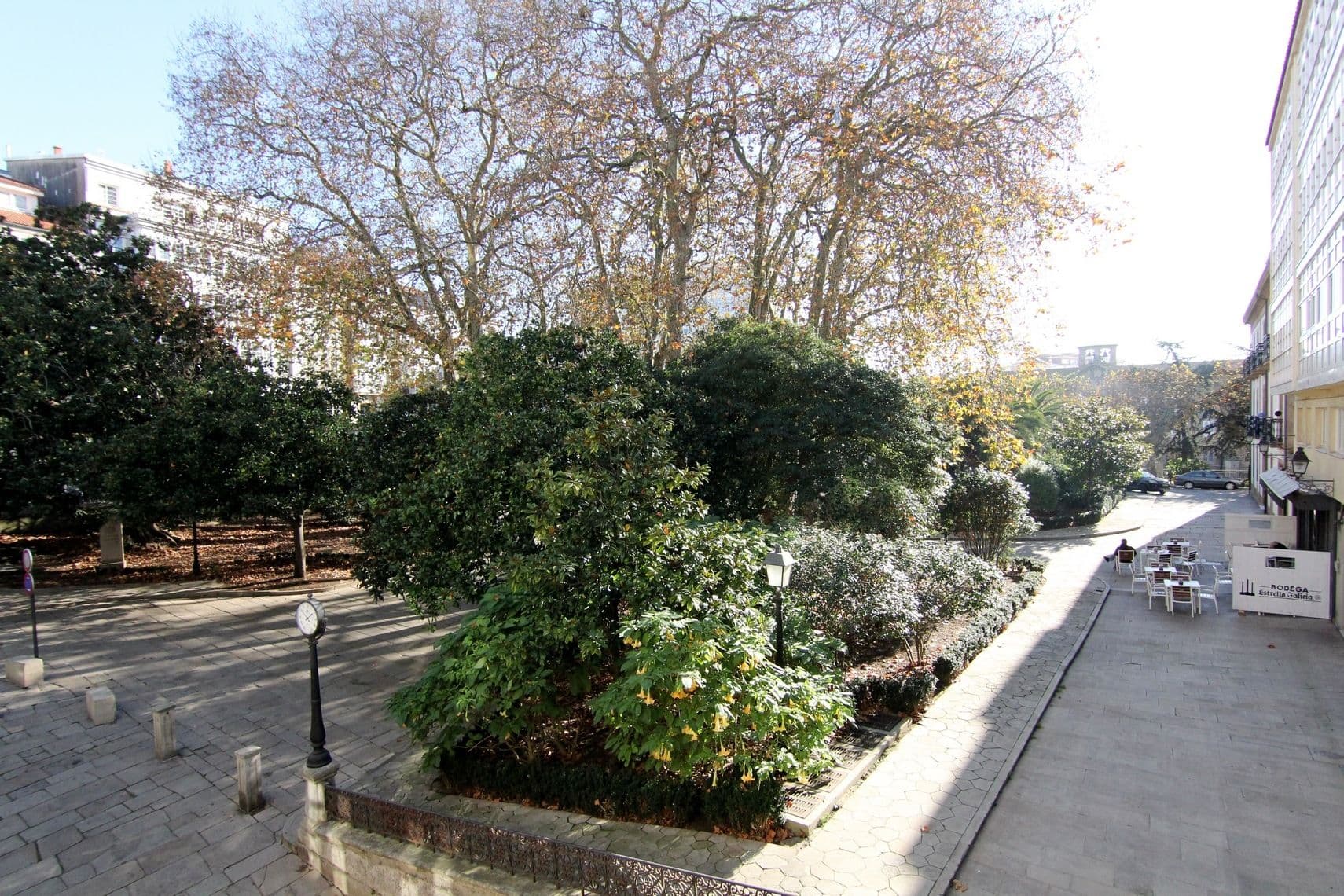 Typical streets view of the old town of Coruña. Park. Trees.