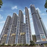 Cluster of modern skyscrapers with glass facades, set against a blue sky, surrounded by palm trees and greenery.