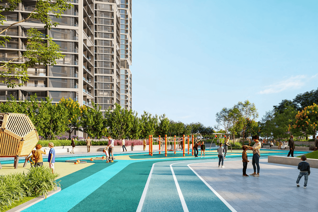 Urban park with a playground, surrounded by trees and a tall building. People are walking and children are playing on a sunny day.