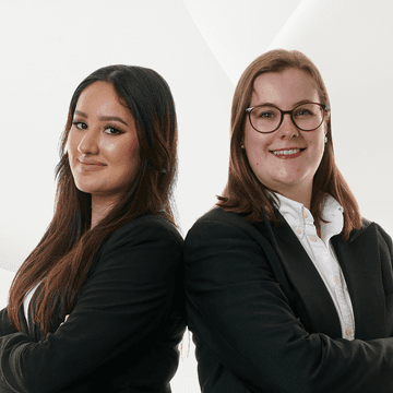 Two recruiters in black blazers back to back