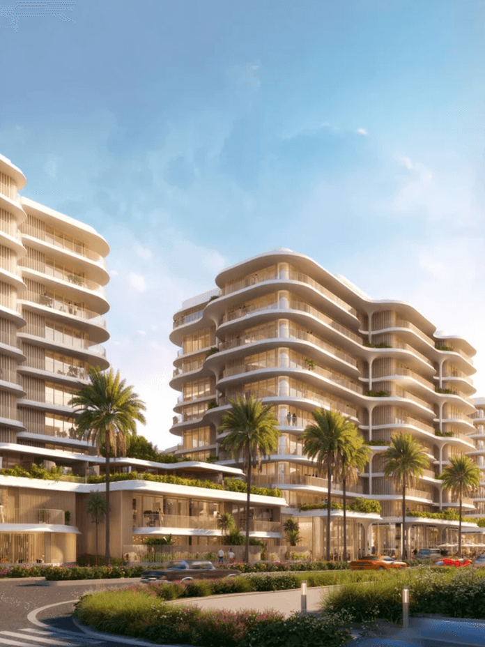 Modern architectural buildings with rounded edges, surrounded by palm trees and a landscaped area under a clear blue sky.