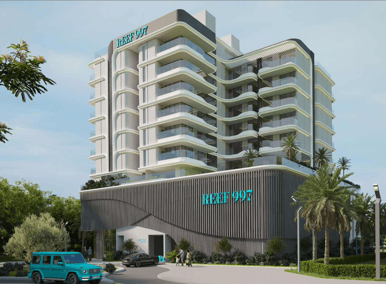 Modern multi-story building with curved balconies, labeled "REEF 997," surrounded by palm trees and greenery, with a parked blue vehicle.