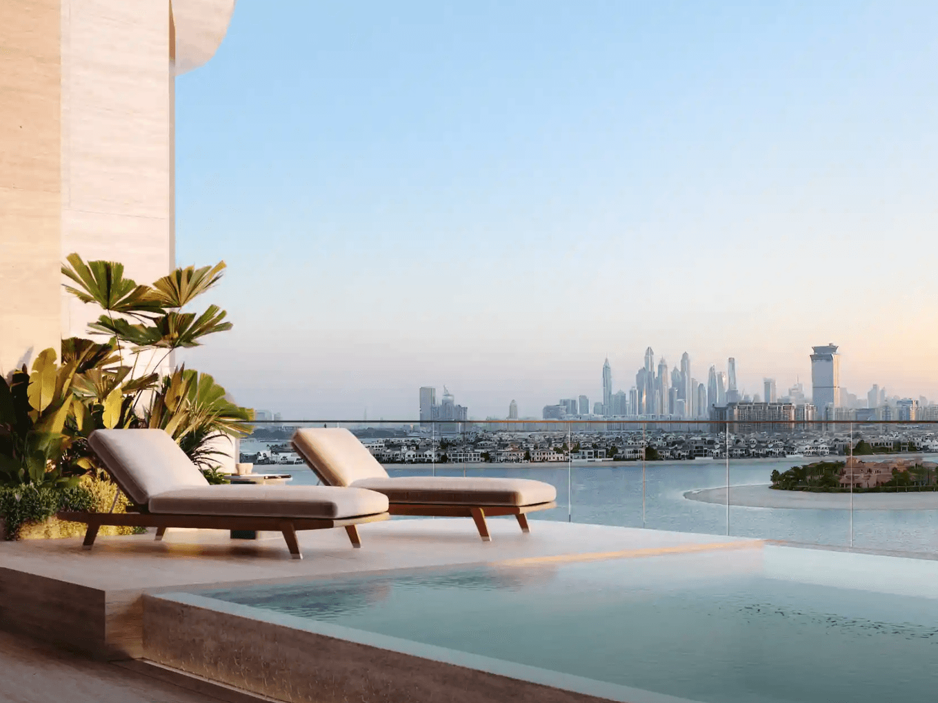 Rooftop infinity pool with two lounge chairs, overlooking a city skyline and waterfront at sunset. Lush plants add a touch of greenery.