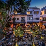 Plaza del Puente Romano with tables and a cosy atmosphere
