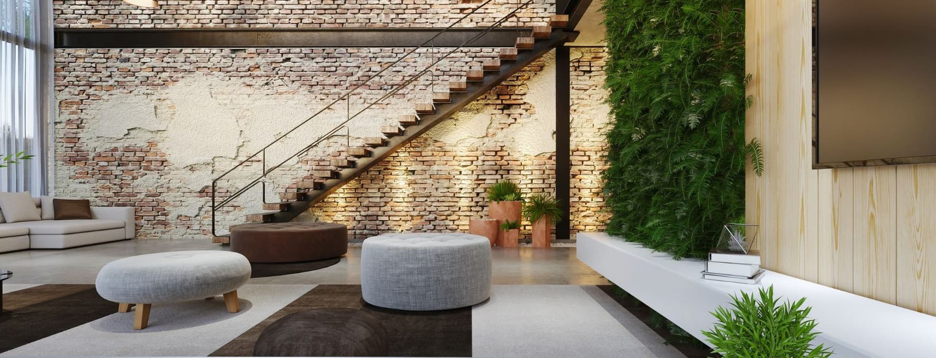Sala d'estar amb paret de maó, escala metàl·lica i jardí vertical. S'hi veuen pufs, auriculars i un telèfon.