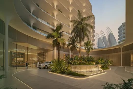 Modern circular building atrium with palm trees, a water feature, and parked car; exterior curves elegantly upward with a backdrop of sunrise.