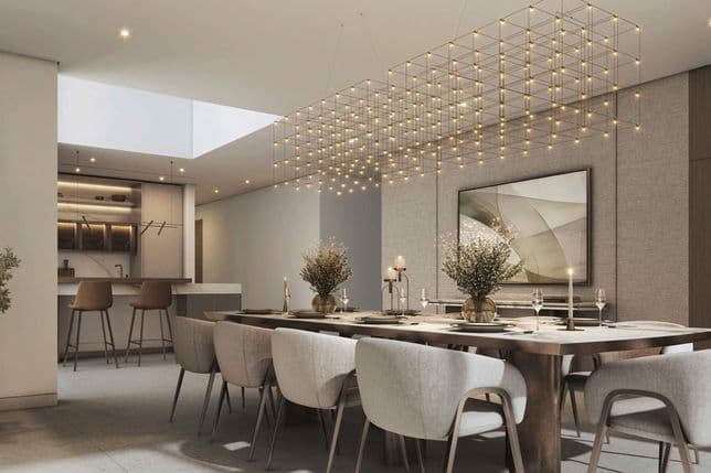 Modern dining room with a large wooden table set for dinner. Elegant chairs, a geometric chandelier, and minimalist decor enhance the space.