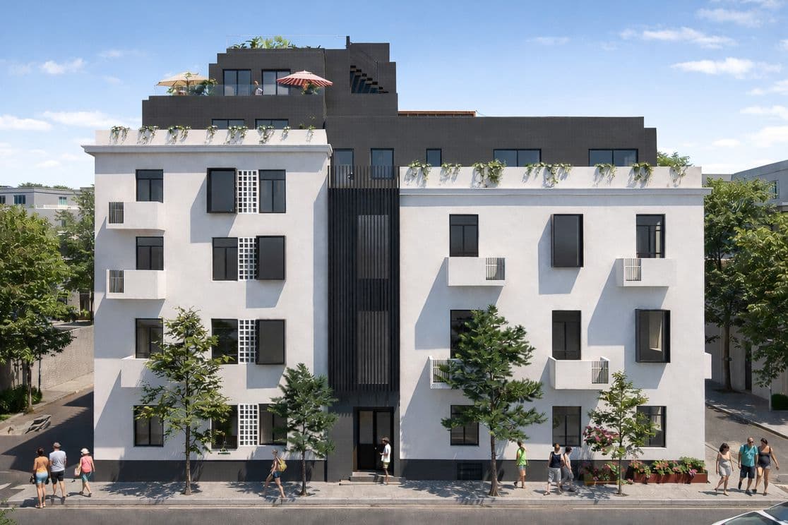 Modern white and dark-gray apartment building with staggered balconies, rooftop terraces and pedestrians walking on the tree-lined sidewalk.