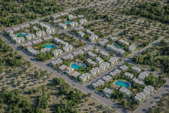 Aerial view of a residential area with multiple houses, roads, and several circular blue pools surrounded by greenery.