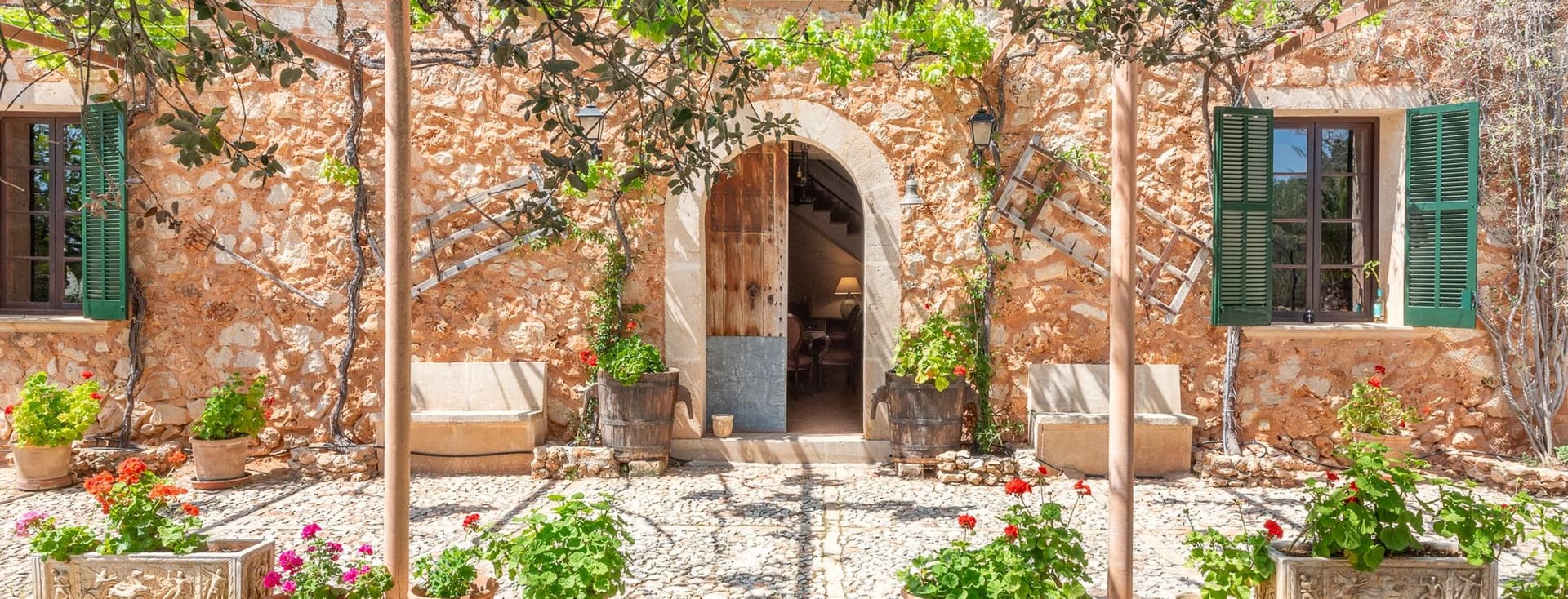 Beautiful natural stone façade of a traditional Mallorcan home in Porreres, showcasing rustic charm and warm Mediterranean character